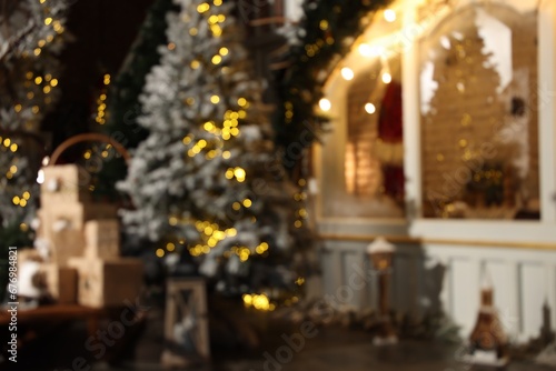 Blurred view of stylish room interior with Christmas tree and festive decor