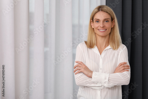 Free Download Portrait of confident entrepreneur or businesswoman with crossed arms, space for text. Beautiful lady with blonde hair smiling and looking into camera - GFXLoad