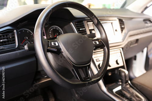 View of steering wheel and dashboard inside of modern car © New Africa