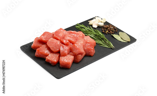 Pieces of raw beef, bay leaves, garlic, rosemary and peppercorns isolated on white photo