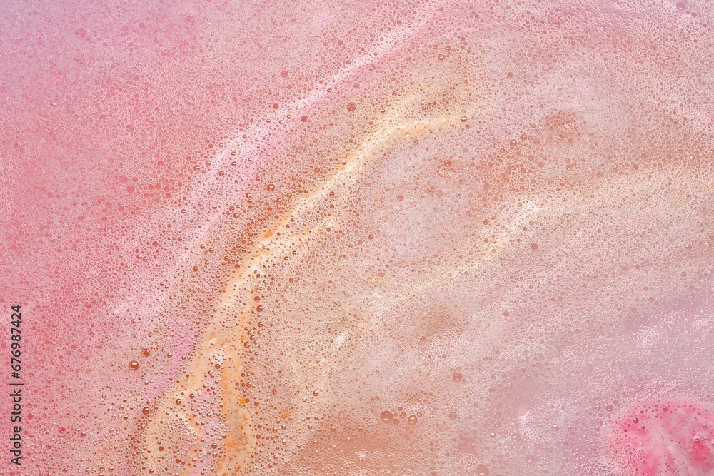 Fototapeta premium Colorful foam after dissolving bath bomb in water, closeup