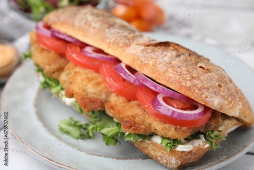Delicious sandwich with schnitzel on white wooden table, closeup