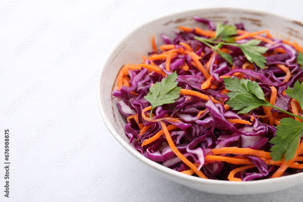Tasty salad with red cabbage in bowl on white table, closeup. Space for text Tasty salad with red cabbage in bowl on white table, closeup. Space for text