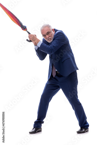 Old businessman holding an umbrella isolated on white