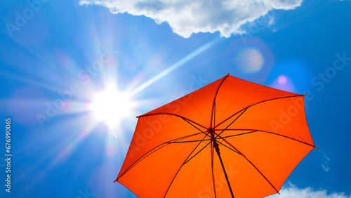 umbrella in the sun against blue sky. Hot summer relaxation and vacation concept
