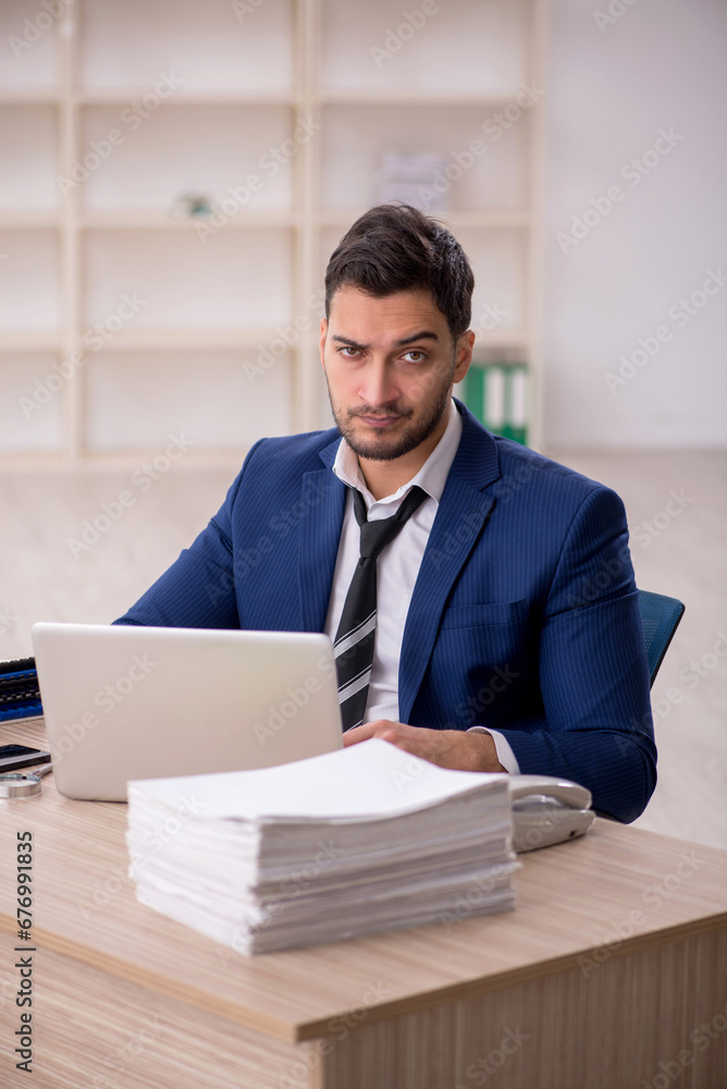 Young male employee working in the office Young male employee working in the office