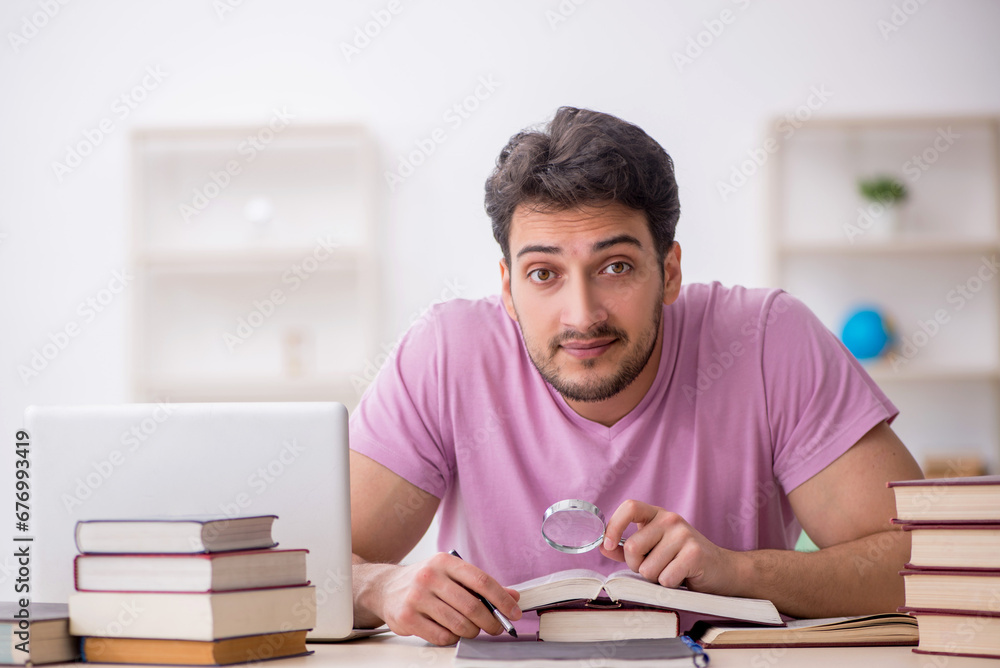 Young male student sitting in the classroom Young male student sitting in the classroom