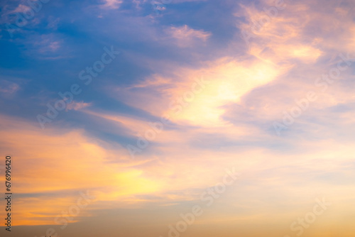 Real amazing Beautiful sunrise and luxury soft gradient orange gold clouds with sunlight on the blue sky perfect for the background, take in everning, Twilight sunset sky with gentle colorful clouds © ISENGARD
