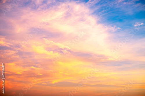 Real amazing Beautiful sunrise and luxury soft gradient orange gold clouds with sunlight on the blue sky perfect for the background, take in everning, Twilight sunset sky with gentle colorful clouds © ISENGARD