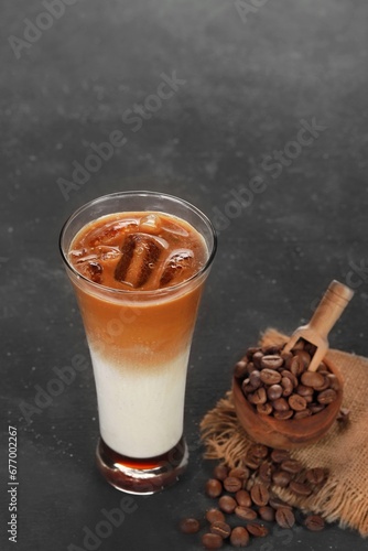 black ice coffee and ice latte coffee with milk in tall glass isolated on white and black background