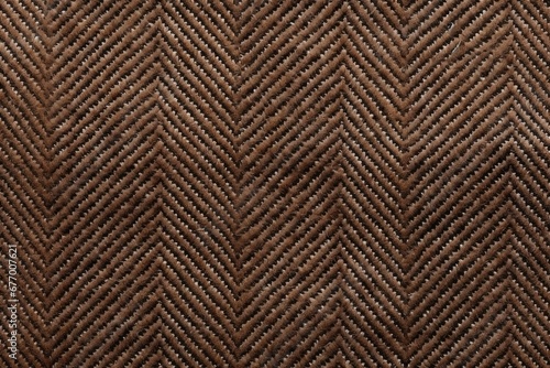 High resolution close up of an expensive man s suit fabric featuring a brown woolen herringbone tweed background with striped zigzag texture