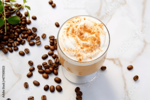Top view of coffee beans and foam on light marble background in a glass, resembling Dalgona coffee.