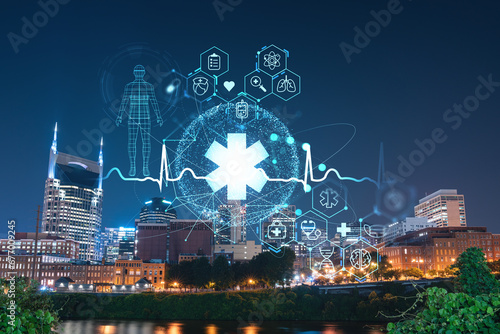 Panoramic view of Broadway district of Nashville over Cumberland River at illuminated night skyline  Tennessee  USA. Hologram healthcare digital medicine icons. The concept of treatment from disease