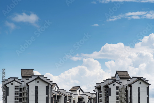 Modern apartment buildings with Chinese style rooftops © xy