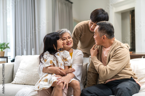 Portrait of happy love family asian father and mother playing with adorable asian kid girl.daughter, care, insurance.Happy family moments good time love with grandparents.Love of big family