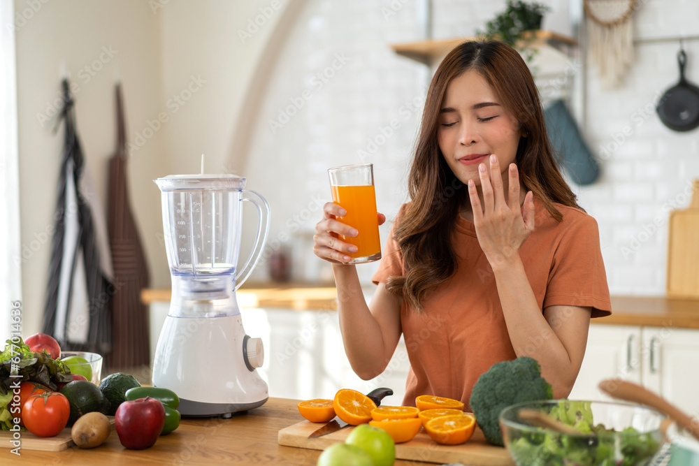 Portrait of beauty healthy asian woman making orange fruit smoothie with blender.girl preparing cooking detox cleanse with fresh orange juice in kitchen at home.health, vitamin c, diet, healthy drink Portrait of beauty healthy asian woman making orange fruit smoothie with blender.girl preparing cooking detox cleanse with fresh orange juice in kitchen at home.health, vitamin c, diet, healthy drink