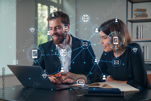 Thoughtful businesspeople typing on laptop at office workplace. Concept of team work, business education, internet surfing, brainstorm, project information technology. Social network hologram photo