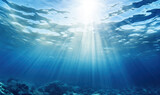 Underwater scene with sunbeams shining through the water surface. High quality photo