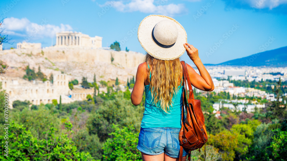 Young female tourist looking at panoramic view of Acropolis, Parthenon in Athens- travel, vacation or tour tourism in Greece