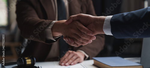 Lawyers shake hands with business people to seal a deal with partner lawyers or a lawyer discussing contract agreements, handshake concepts, agreements. photo
