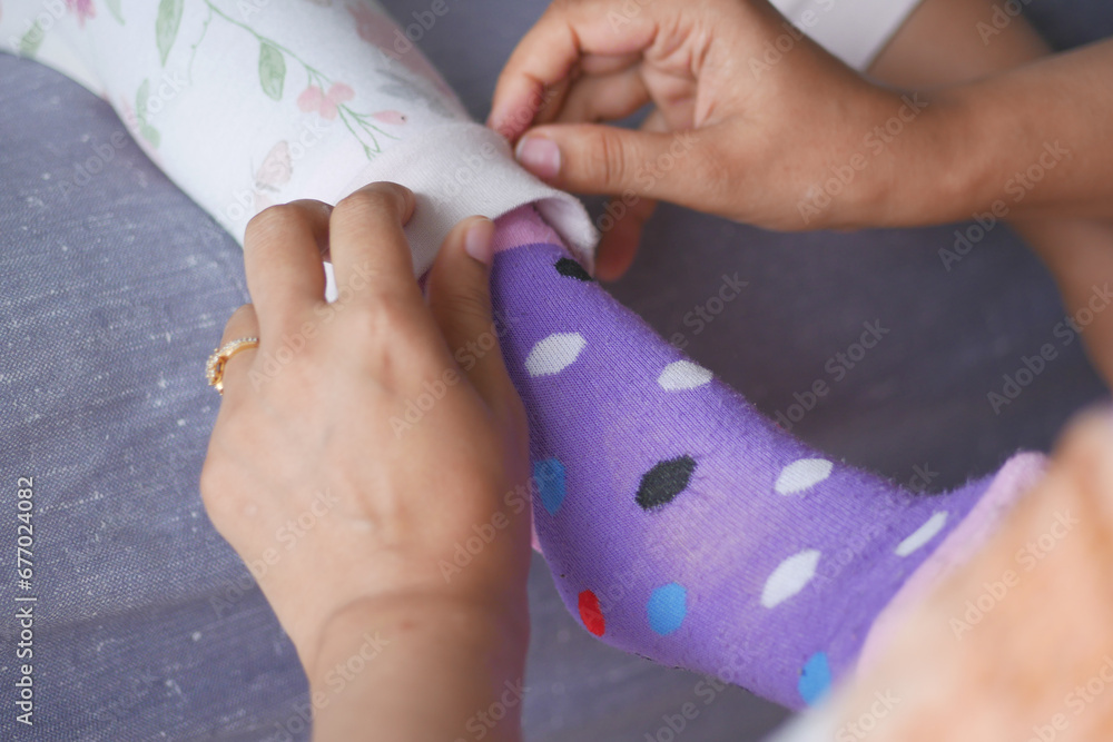 putting on a sock on child feet putting on a sock on child feet