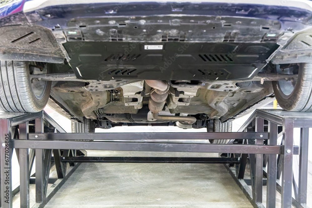 Close-up of the bottom of the car with a view of the car's undercarriage.