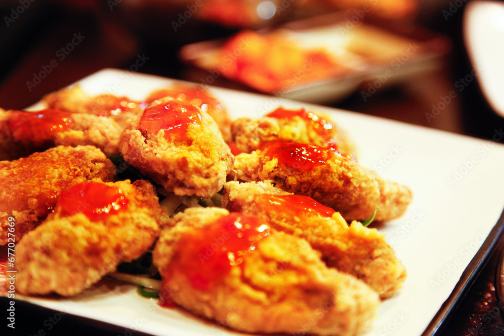 Korean style fried chicken wings Topped with chili sauce, close up, seletive focus Korean style fried chicken wings Topped with chili sauce, close up, seletive focus