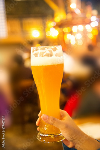 woman holding A Glas of weiss beer Original German style beer Popular in Japan, Otaru, Hokkaido, Japan photo