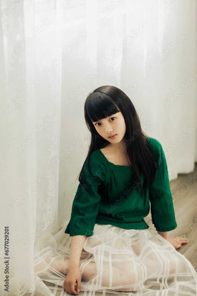 Asian little girl wearing green clothing Asian little girl wearing green clothing