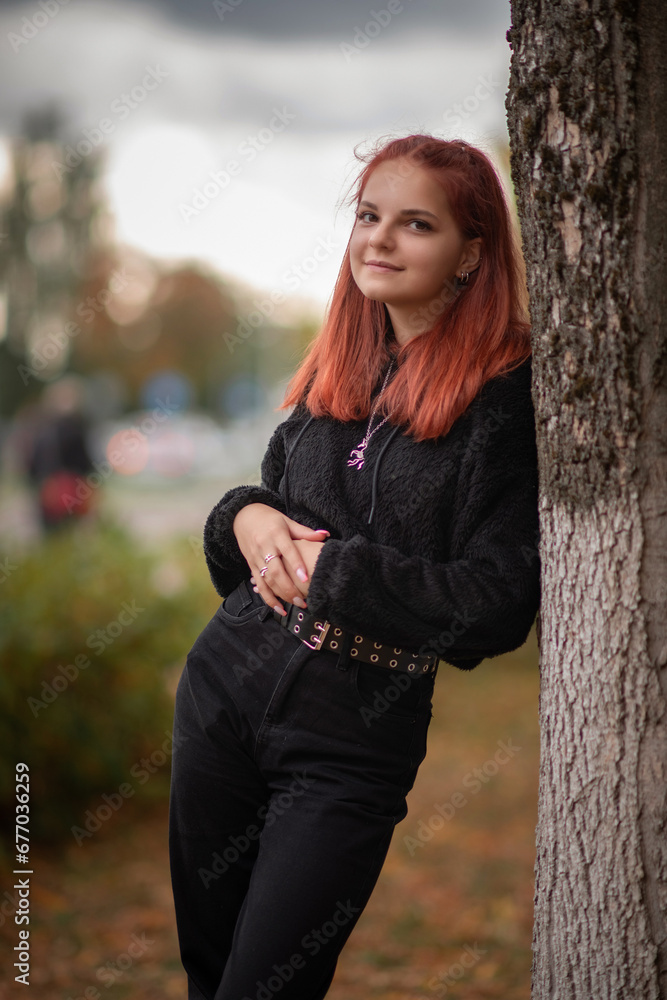 Portrait of a young beautiful red-haired girl in an autumn park. Portrait of a young beautiful red-haired girl in an autumn park.