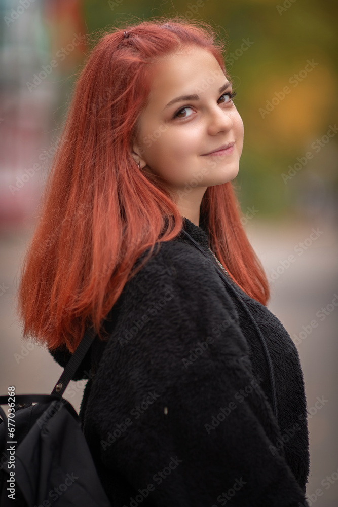 Portrait of a young beautiful red-haired girl in an autumn park. Portrait of a young beautiful red-haired girl in an autumn park.