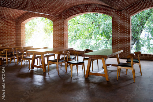 Red brick restaurant with tables and chairs © xy