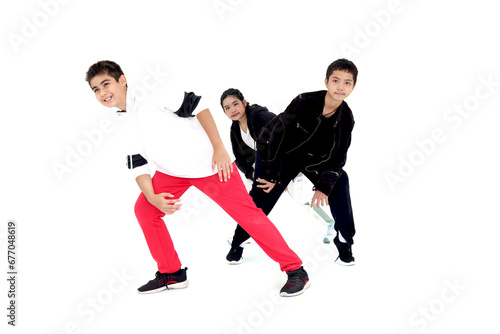 Happy student kid group studying modern style dance in indoor studio classroom, children, boys and girl, dancing on white background. Three little dancers practicing break dance together.