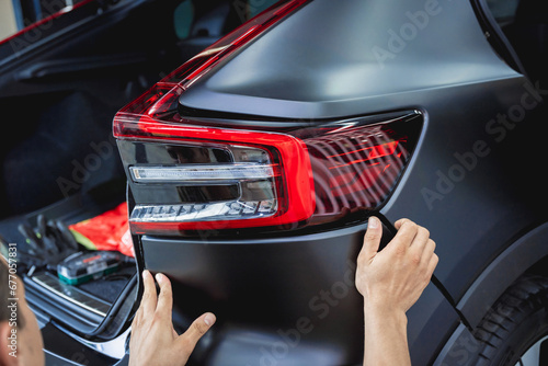 Replacing spare parts on a disassembled car in a car service garage