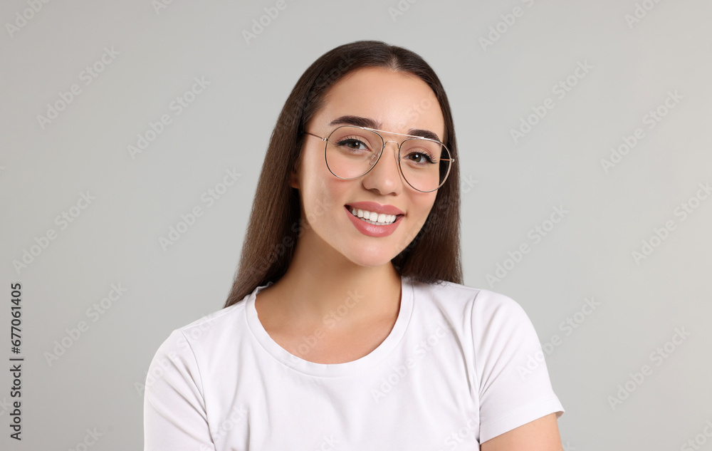Beautiful woman wearing glasses on light gray background Beautiful woman wearing glasses on light gray background