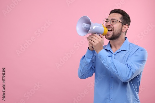 Special promotion. Man shouting in megaphone on pink background. Space for text