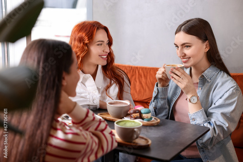 Happy friends spending time together in cafe