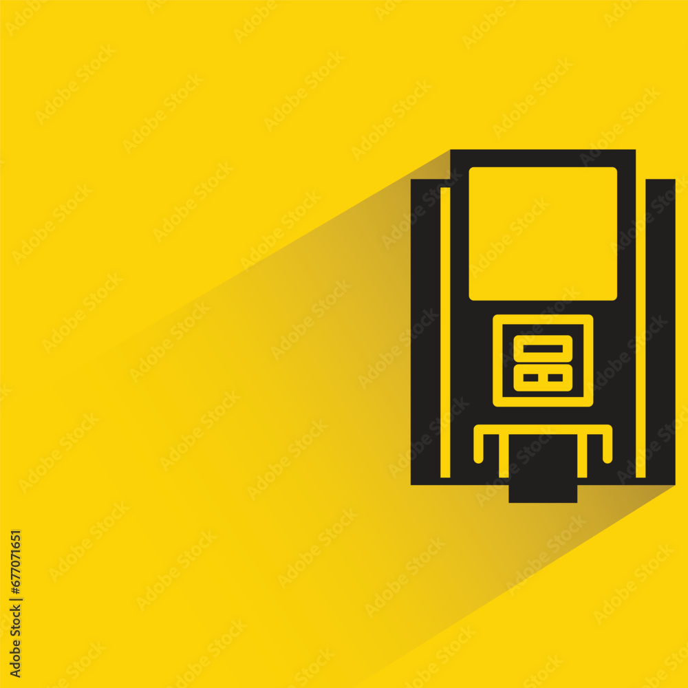 atm with shadow on yellow background atm with shadow on yellow background