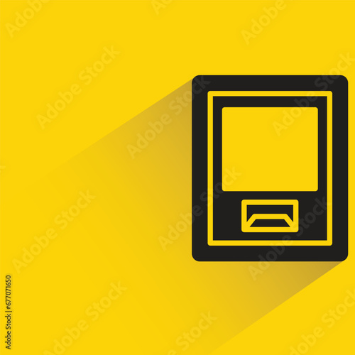 atm with shadow on yellow background