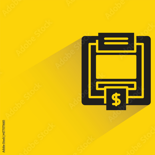 atm with shadow on yellow background