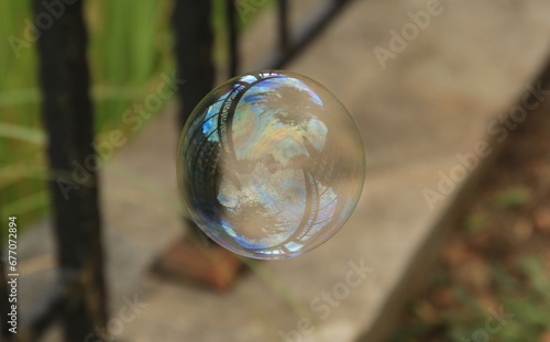 One beautiful clear soap bubble floating outdoors © New Africa
