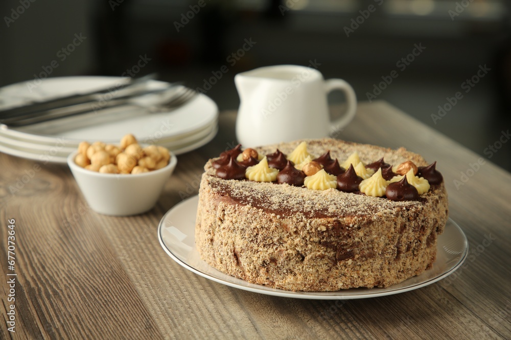 Delicious Kyiv Cake with cream and hazelnuts served on wooden table Delicious Kyiv Cake with cream and hazelnuts served on wooden table