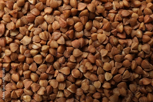 Dry buckwheat grains as background  top view