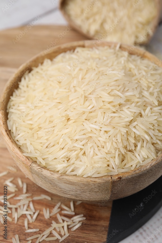 Raw rice in bowl on table, closeup Raw rice in bowl on table, closeup
