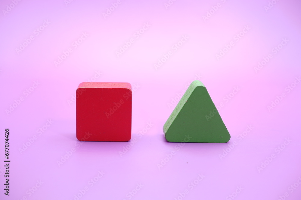 Set of colorful wooden shape toy. Square and triangle on Purple background Set of colorful wooden shape toy. Square and triangle on Purple background
