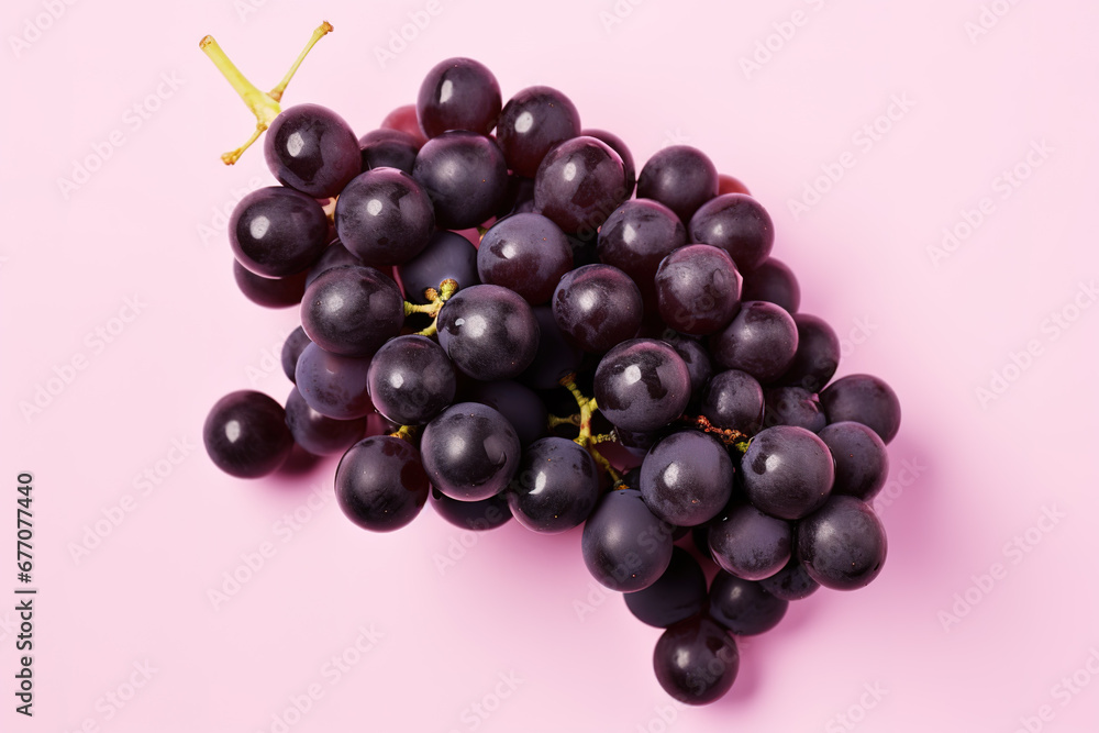 black grapes on a pink background black grapes on a pink background