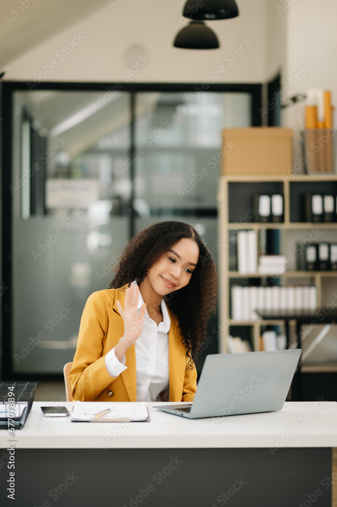Business woman Talking on the phone and using a laptop at office. Business woman Talking on the phone and using a laptop at office.
