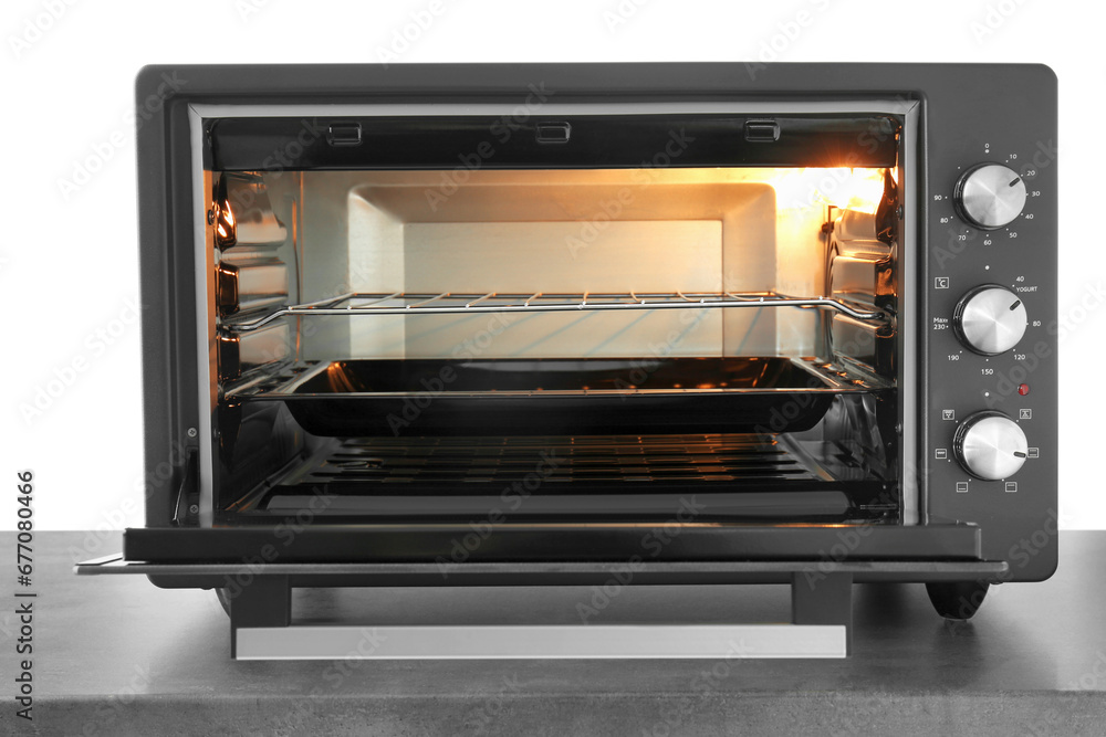 One electric oven on grey table against white background One electric oven on grey table against white background