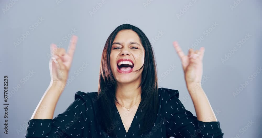 Face, rock and roll with woman, hand and happiness with an attitude on a grey studio background. Portrait, person and model with emoji, symbol or heavy metal music with a smile, energy and culture Face, rock and roll with woman, hand and happiness with an attitude on a grey studio background. Portrait, person and model with emoji, symbol or heavy metal music with a smile, energy and culture