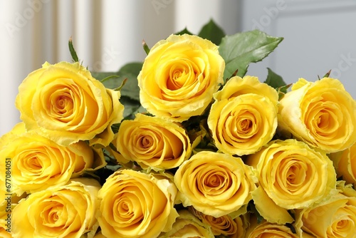 Beautiful bouquet of yellow roses against blurred background  closeup